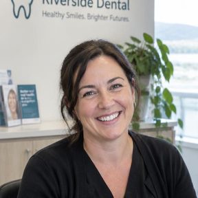 Smiling dental receptionist at the clinic front desk